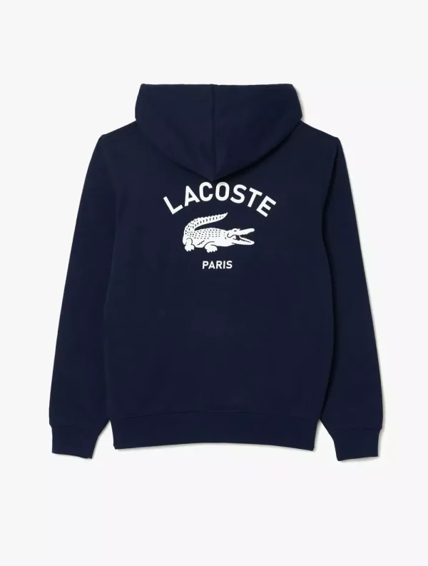 Hoodie Lacoste navy dengan logo buaya dan tulisan 'Lacoste Paris' di bagian belakang